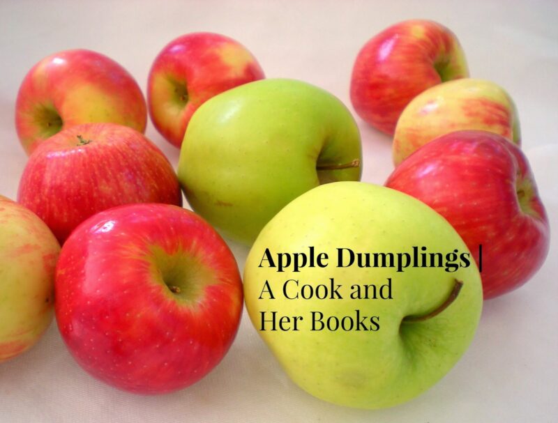 Red and green apples on. a table