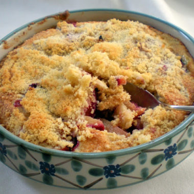 Plum crumble dessert in a ceramic dish