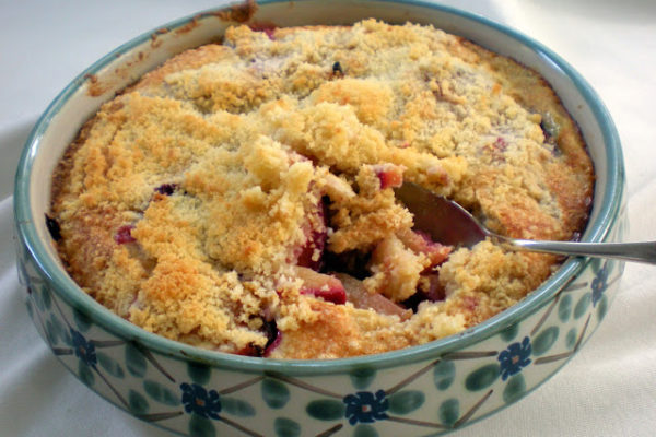 Plum crumble dessert in a ceramic dish