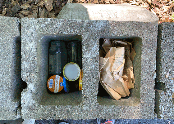 Jars and paper in cinder blocks