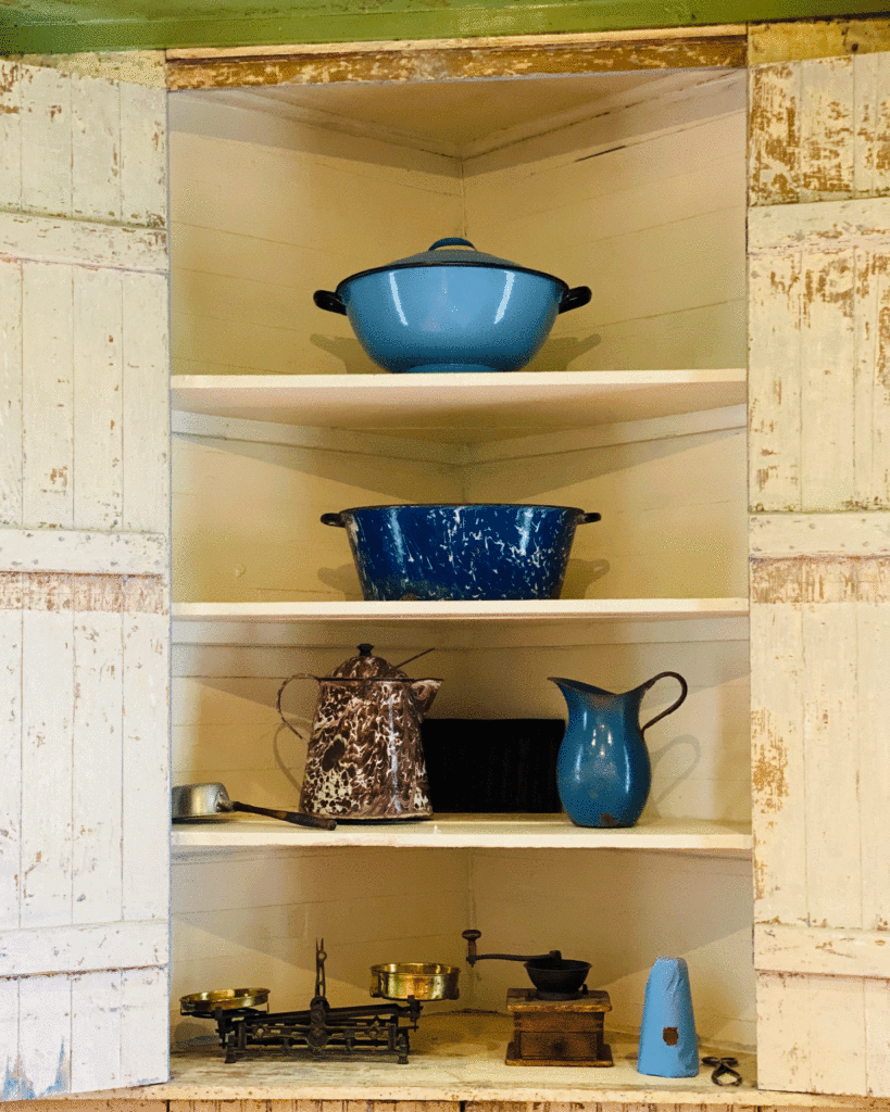 Blue dishes in a corner cabinet | Photo by Lucy Mercer | A Cook and Her Books