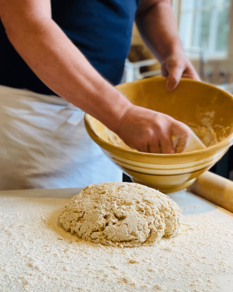 Scraping dough onto floured surface | Photo by Lucy Mercer / A Cook and Her Books