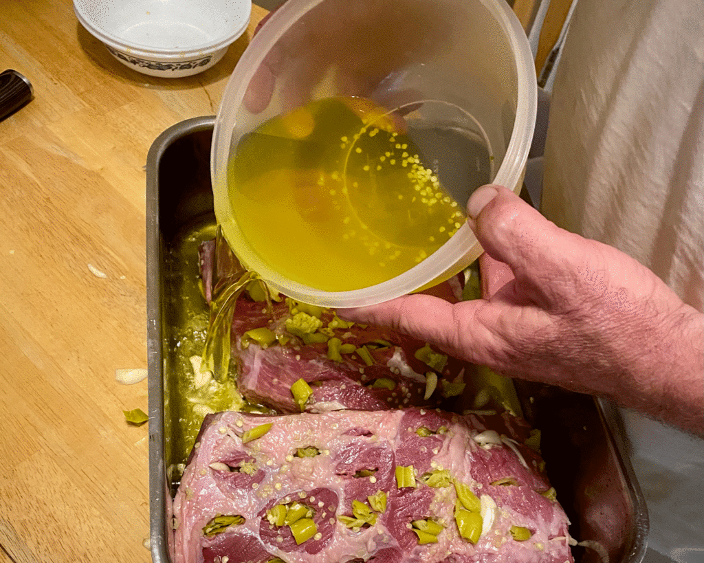Pouring pepperoncini brine over roast | Photo by Lucy Mercer | A Cook and Her Books