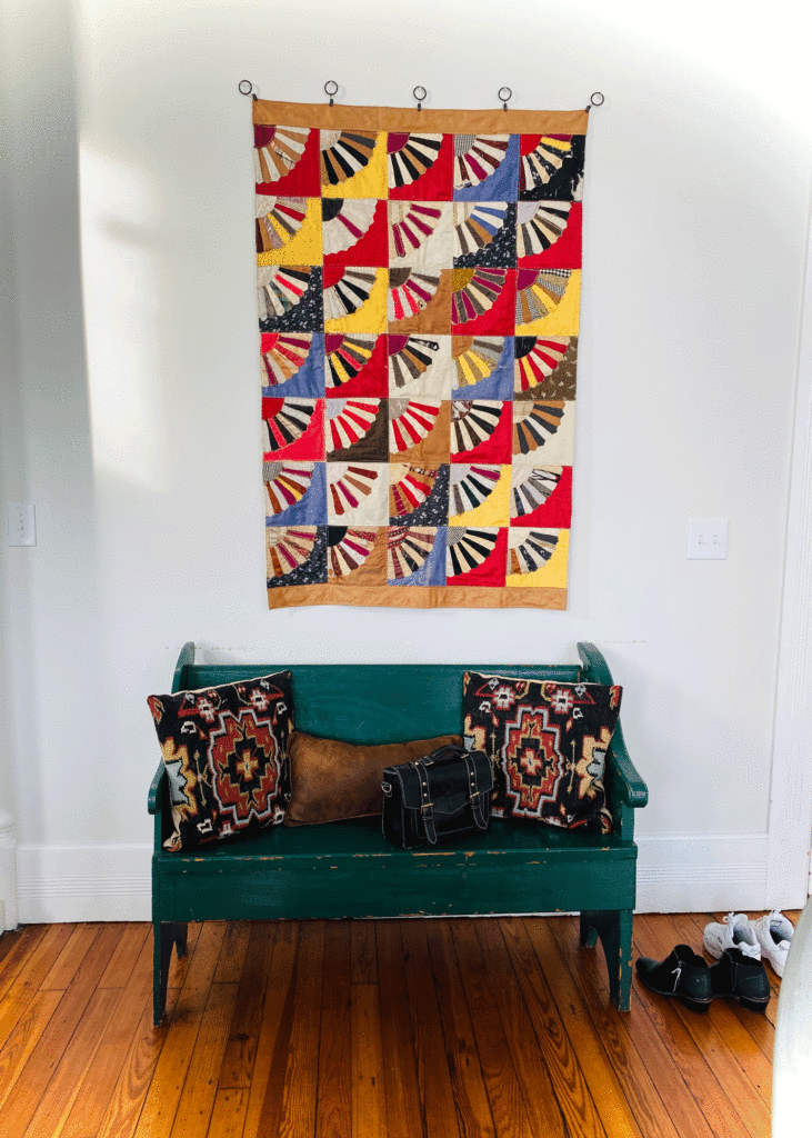 Quilt on wall above bench | Photo by Lucy Mercer | A Cook and Her Books