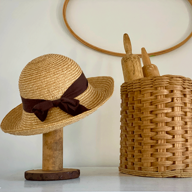 Hat on stand with basket of rolling pins