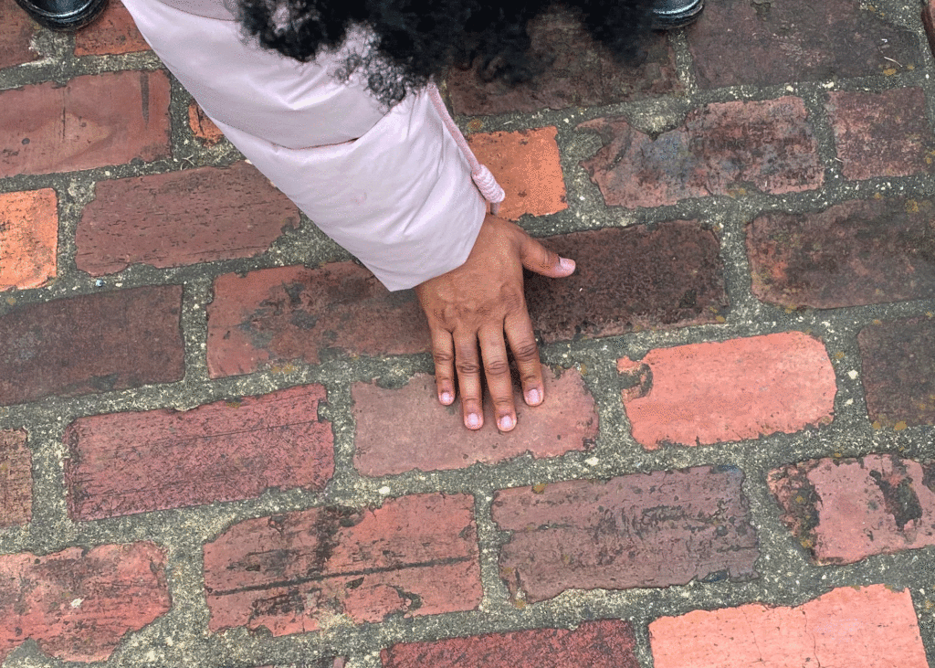 Abra Lee touches the bricks at Oakland Cemetery | Photo by Lucy Mercer/A Cook and Her Books