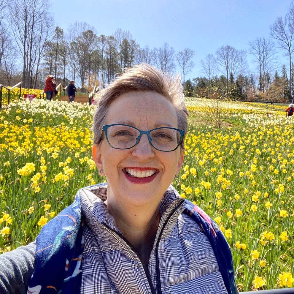 Woman in field of daffodils