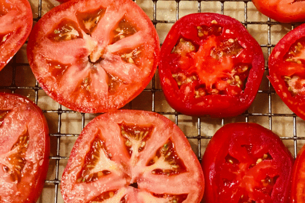 Sliced red tomatoes on a grid