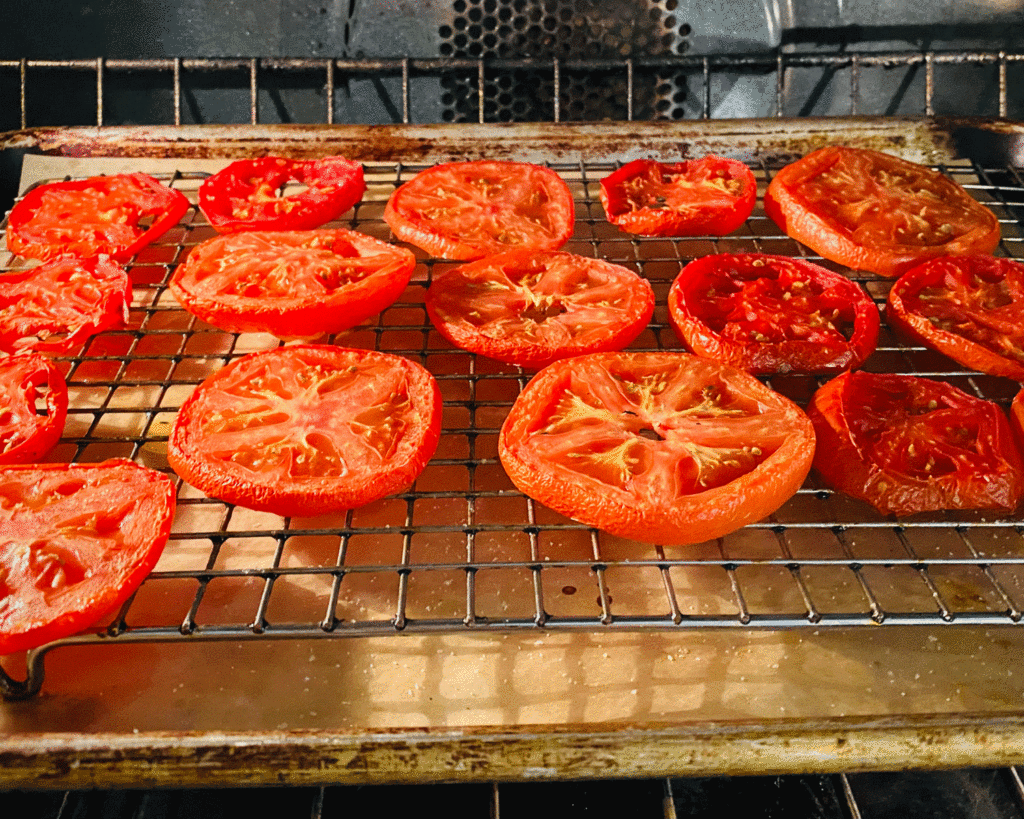 Sliced tomatoes on grid on baking sheet | Photo by Lucy Mercer/A Cook and Her Books