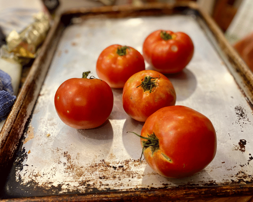 Tomatoes on a sheet pan | Photo by Lucy Mercer/A Cook and Her Books