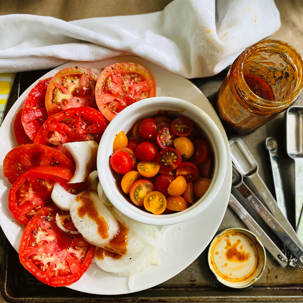 Sliced tomatoes on a plate | Photo by Lucy Mercer/A Cook and Her Books