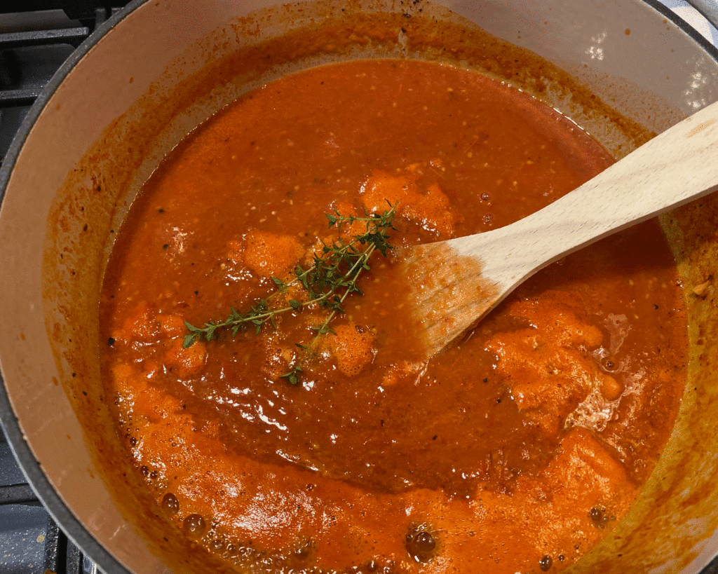 Wooden spoon in tomato soup | Photo by Lucy Mercer/A Cook and Her Books