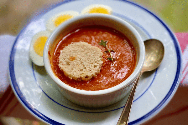 Tomato soup on a white plate | Photo by Lucy Mercer/A Cook and Her Books
