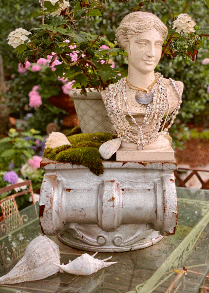 Bust of a woman on a table in a garden
