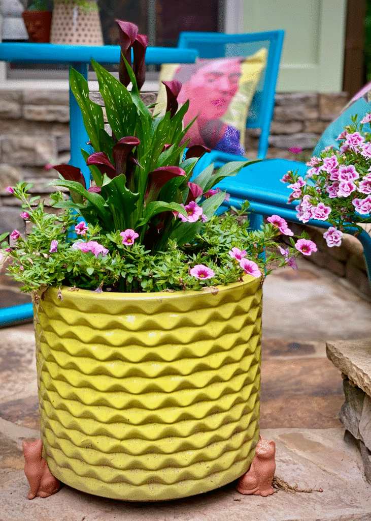 Flowers in a yellow planter in a garden