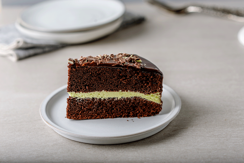 Slice of chocolate mint layer cake on plate