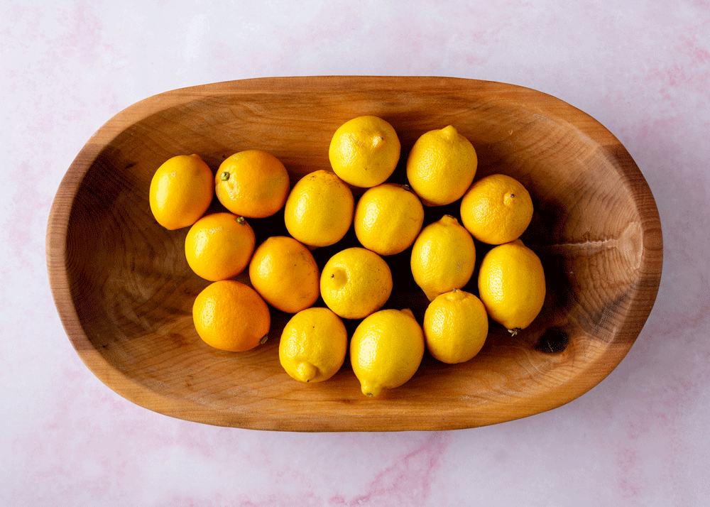Meyer lemons and regular lemons in a wooden bowl
