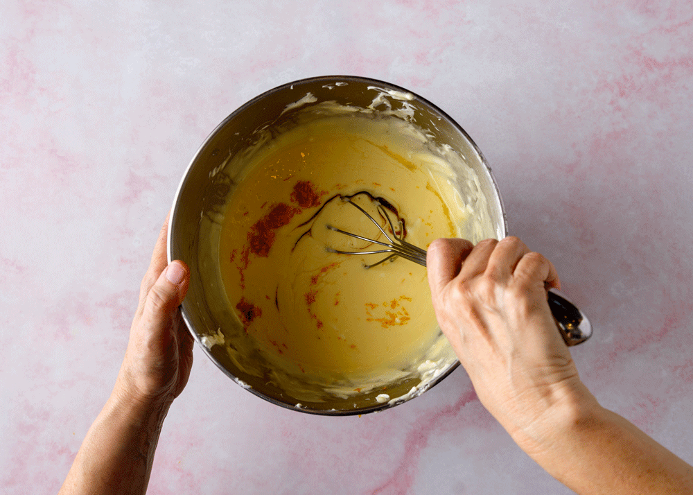 Cook whisks zest and flavorings into the filling batter