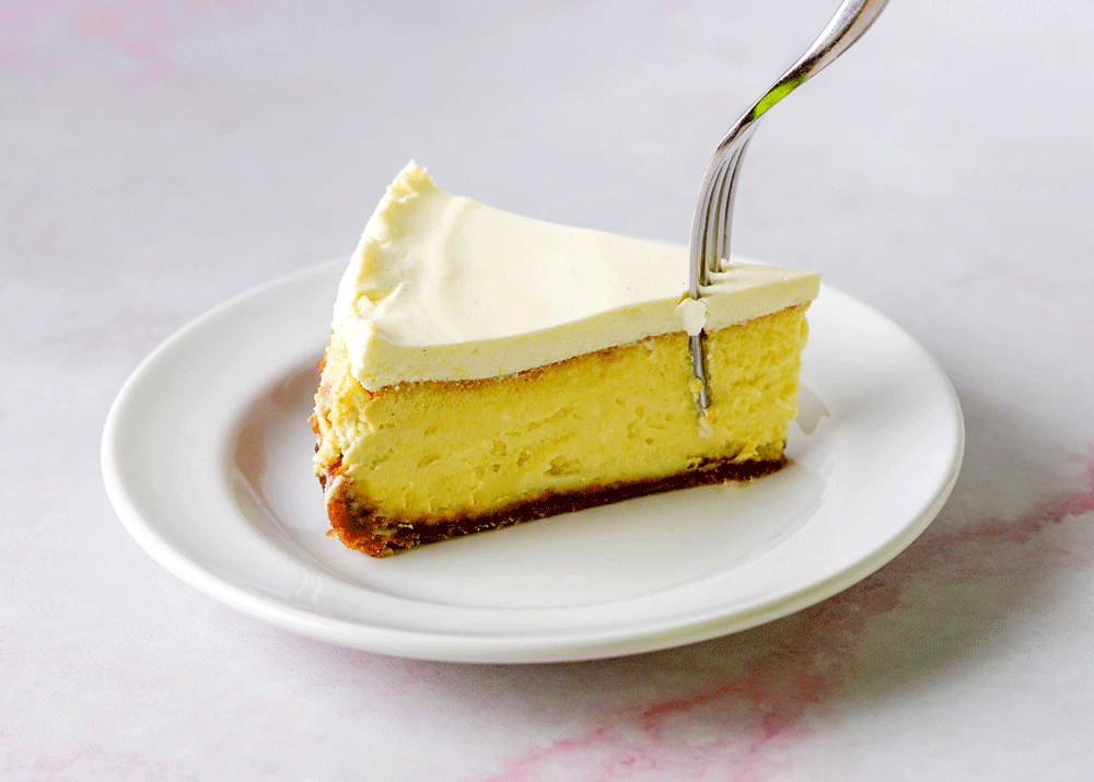 Lemon cheesecake on a plate with a fork