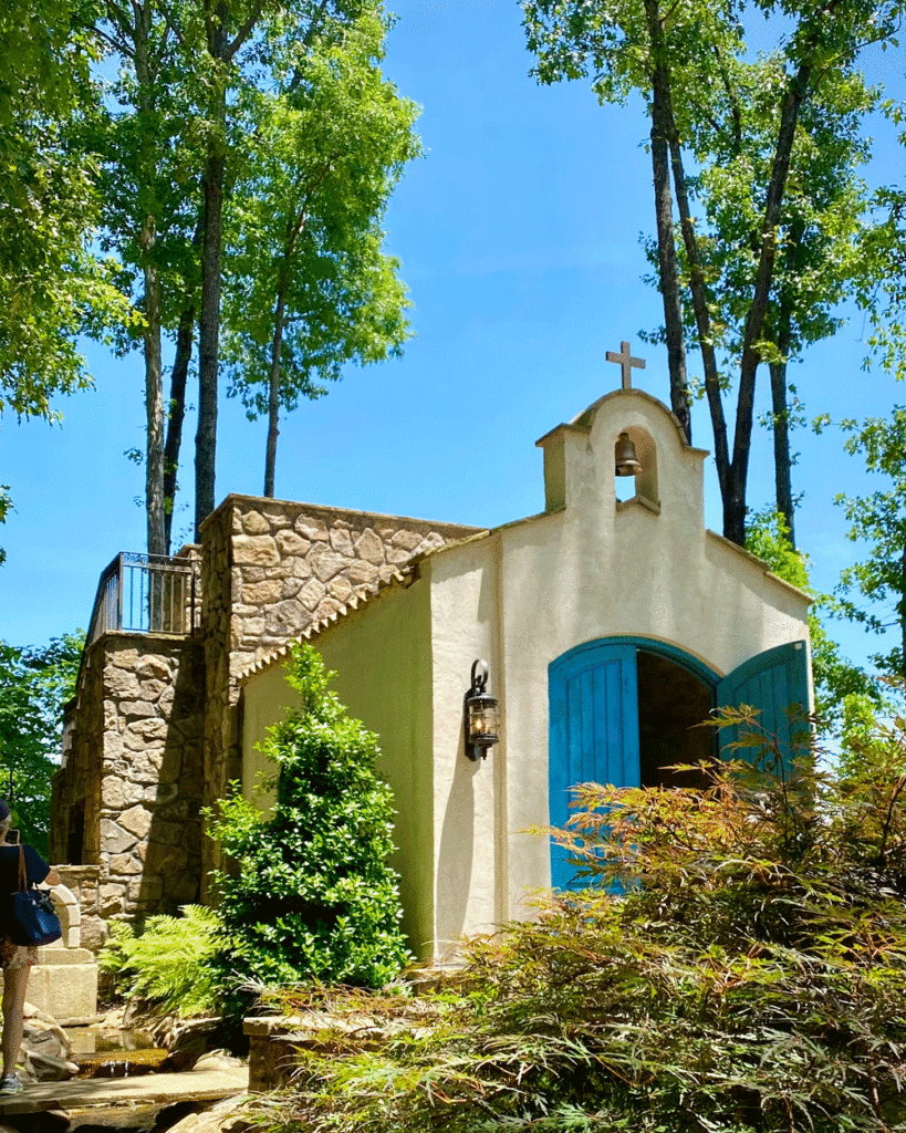 White chapel with blue doors in gardens