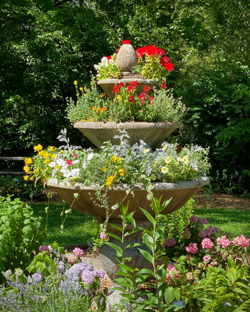 Tiered fountain filled with bright summer annuals