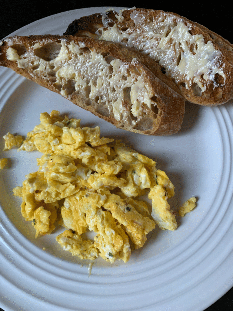 Buttered artisan bread with scrambled eggs