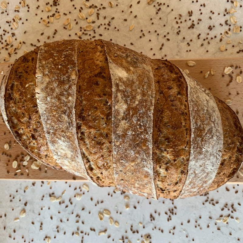 Loaf of multigrain bread on a cutting board
