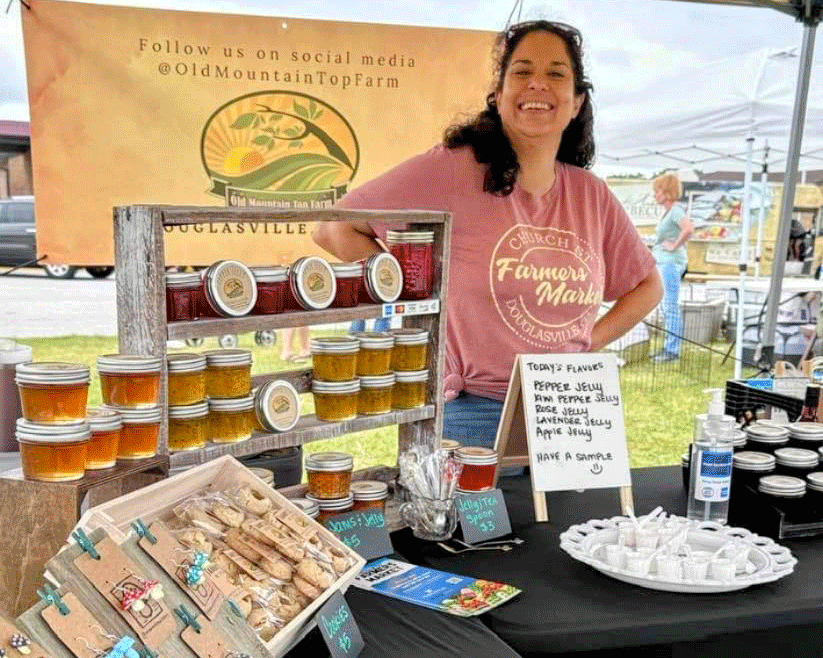 Leila Davis of Old Mountaintop Farm in her farmers market booth