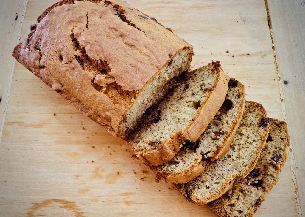 Banana bread with chocolate chips on a bread board