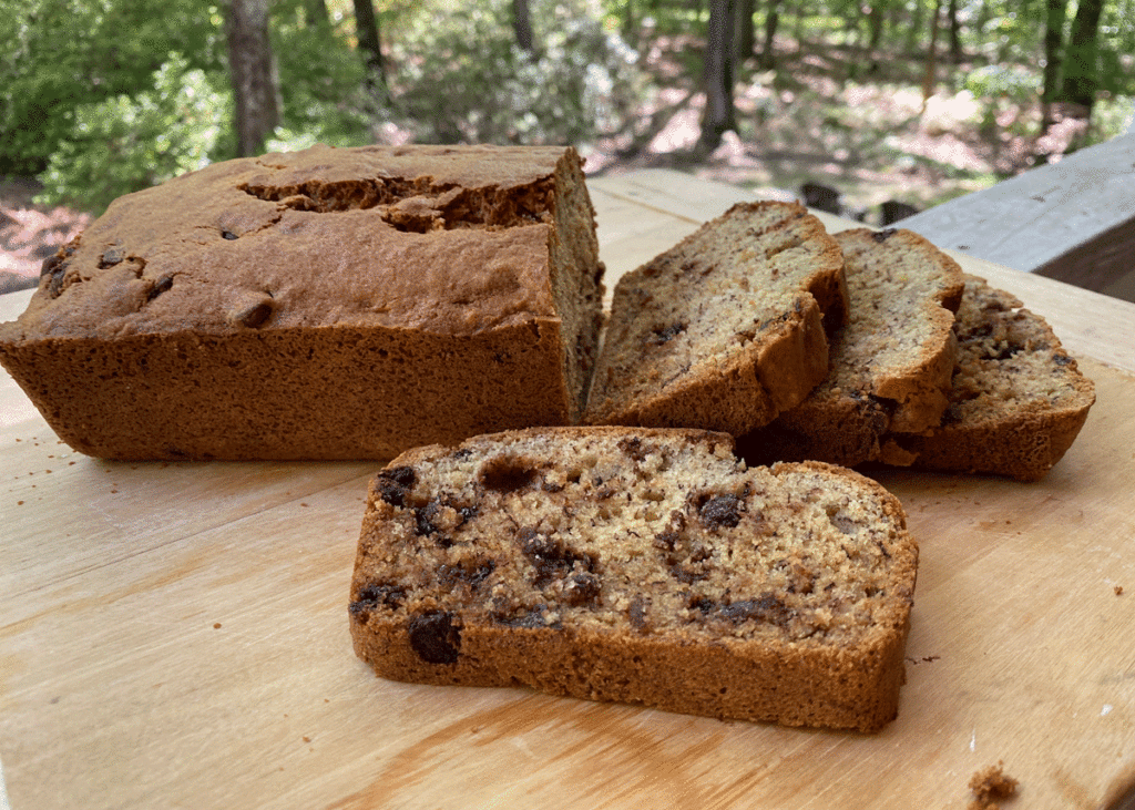 Slices of banana bread with chocolate chips on a wood board
