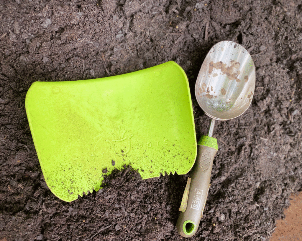 Green plastic soil scoop and metal soil scoop 