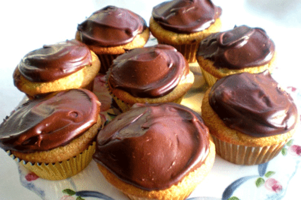 Banana cupcakes with chocolate frost ing on a cake plate