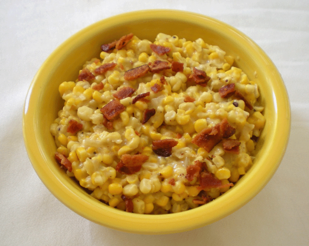 Corn cooked with bacon in a yellow bowl