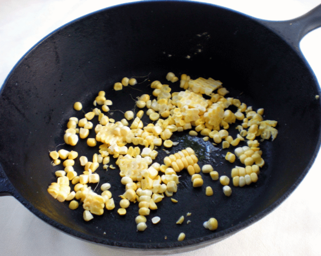 Cast iron skillet with fresh corn kernels