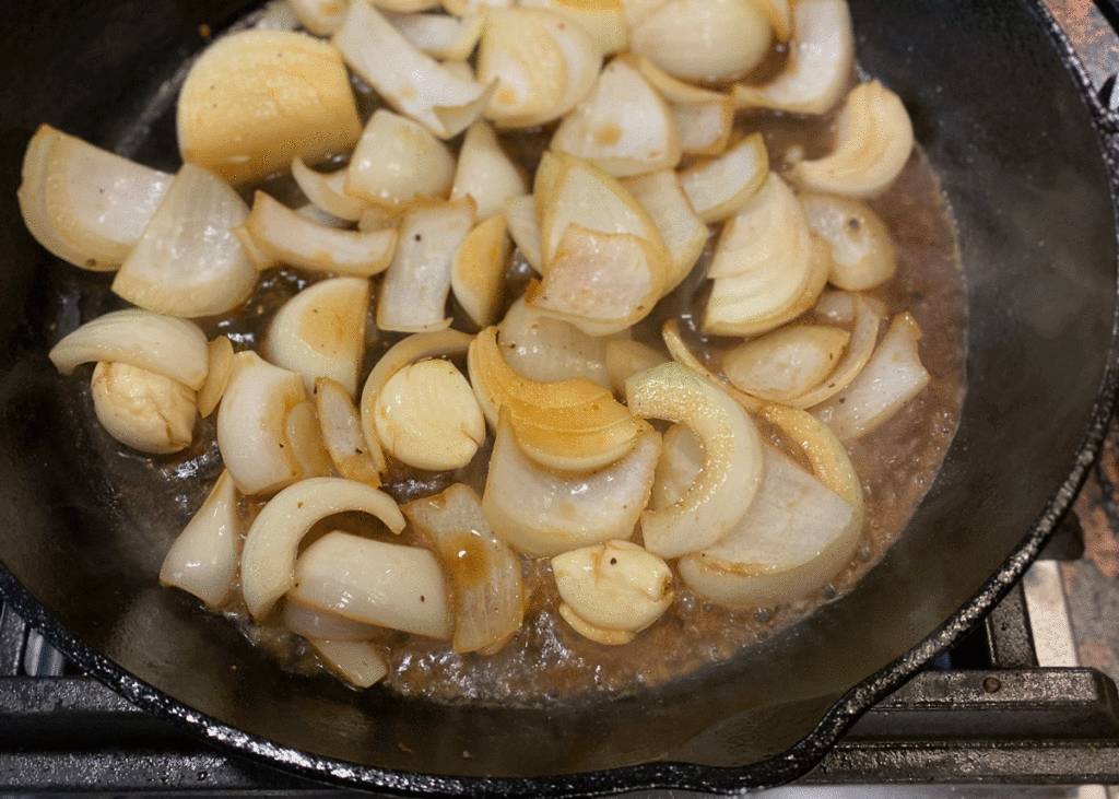 Onions browning in a cast iron pan