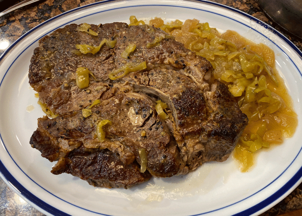 Mississippi pot roast on a platter with sauce