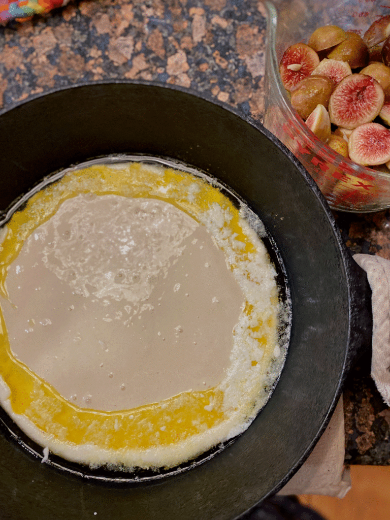 Batter in a cast iron skillet on a granite counter