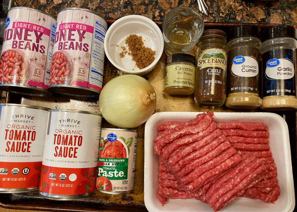 Ingredients for chili: ground beef, beans, spices on a tray