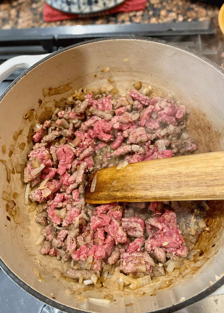 Ground beef browning in a Dutch oven