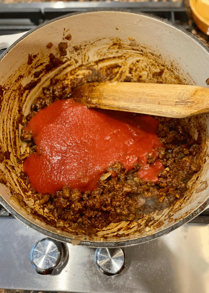 Tomato sauce added to ground beef mixture