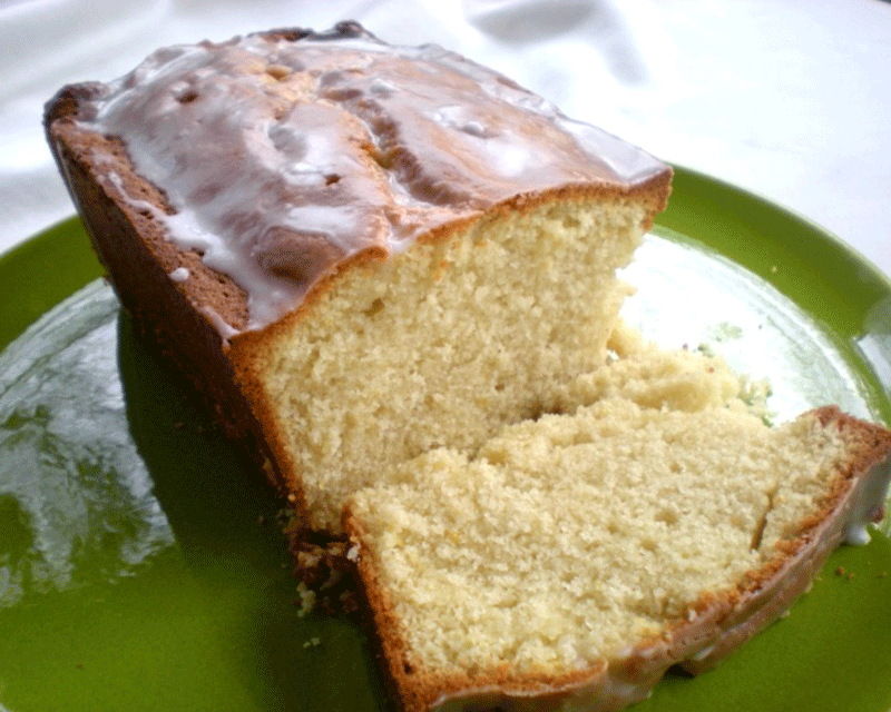 Meyer lemon tea loaf cake sliced on a green plate