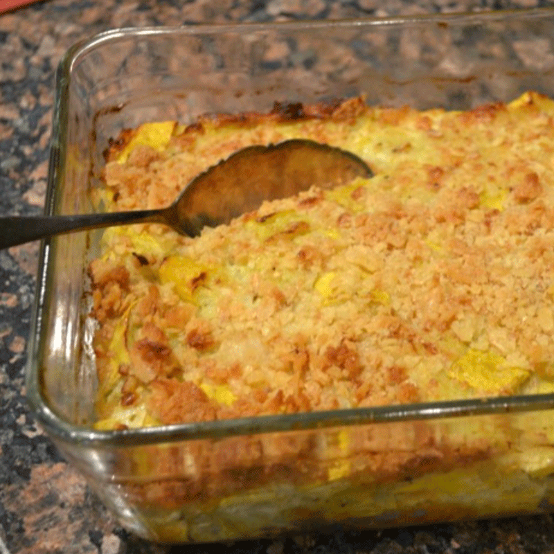 Squash casserole in a dish with a spoon