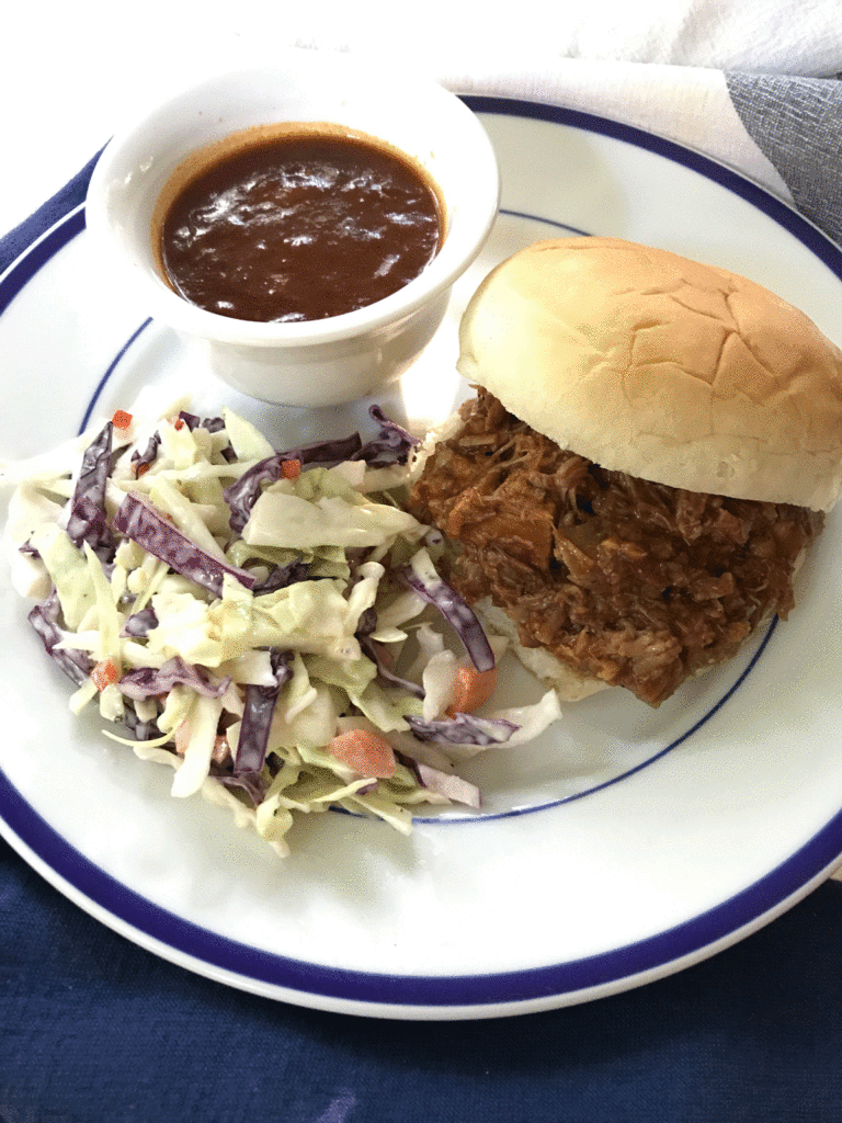 Pulled pork sandwich with slaw and barbecue sauce