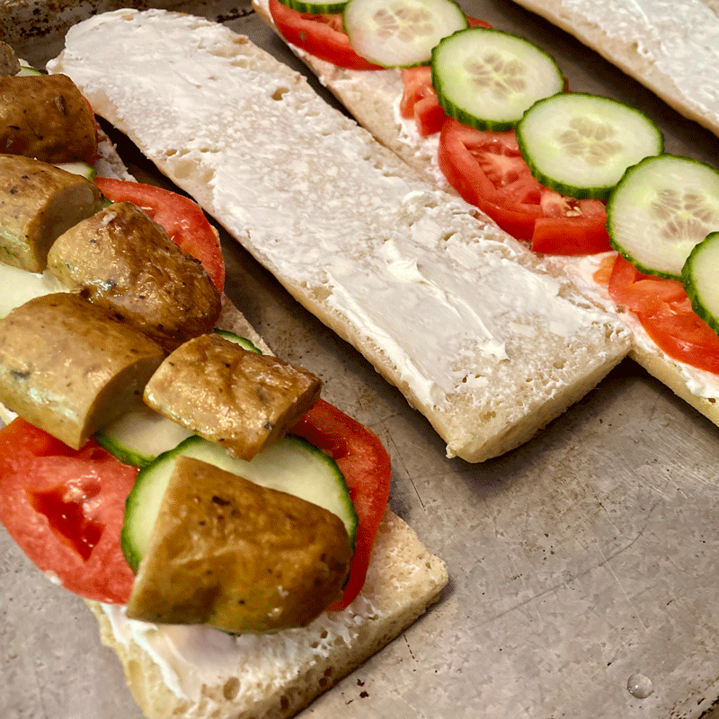 Ukrainian sandwich with sausage, tomato and cucumber on buttered bread