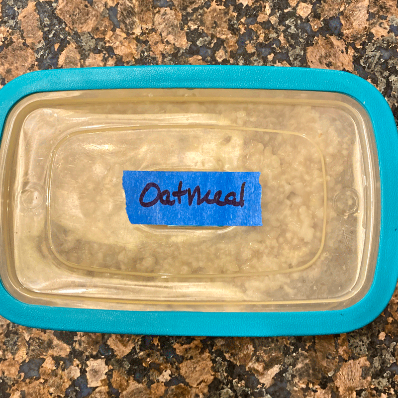 Plastic food container with blue "oatmeal" label