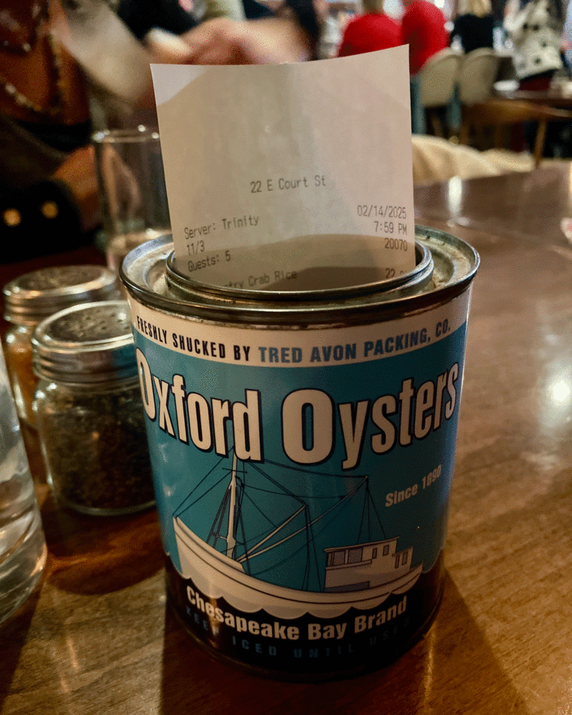 Restaurant check presented in oyster can