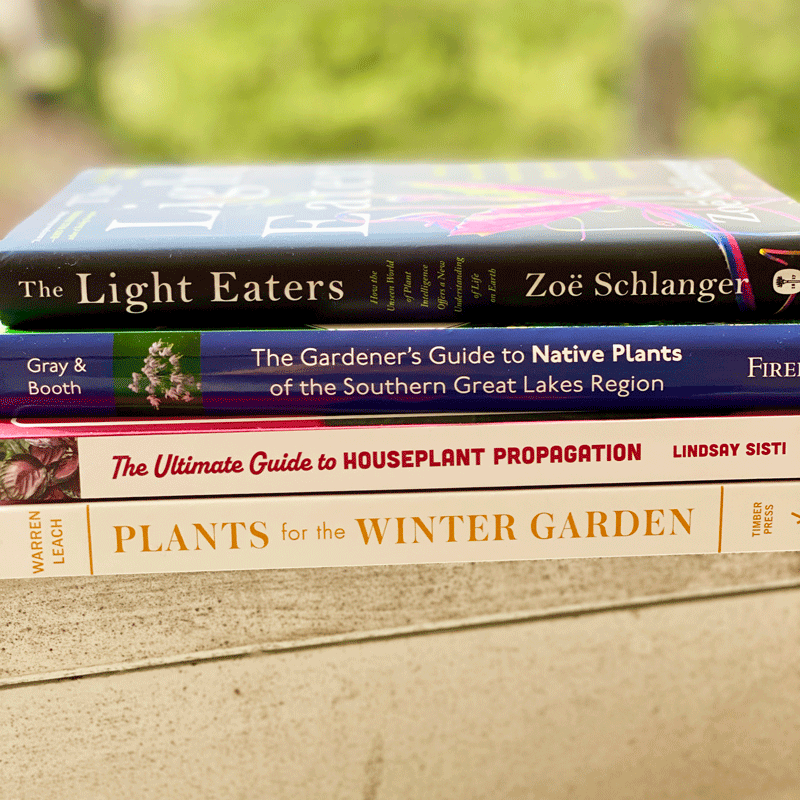 Award winning gardening books stacked on a railing