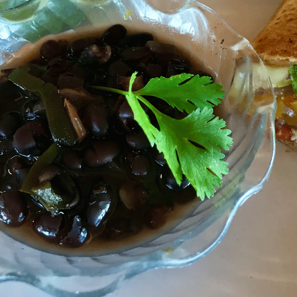 Cilantro leaf on a bowl of black beans