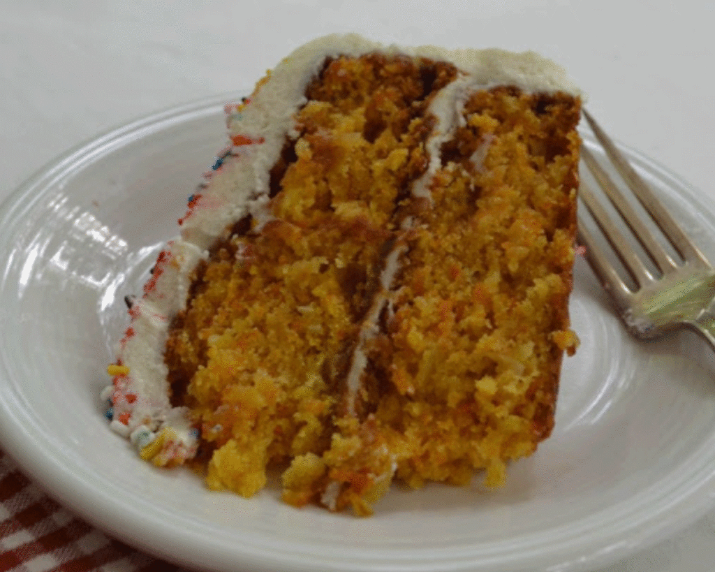 Slice of carrot cake on a white plate