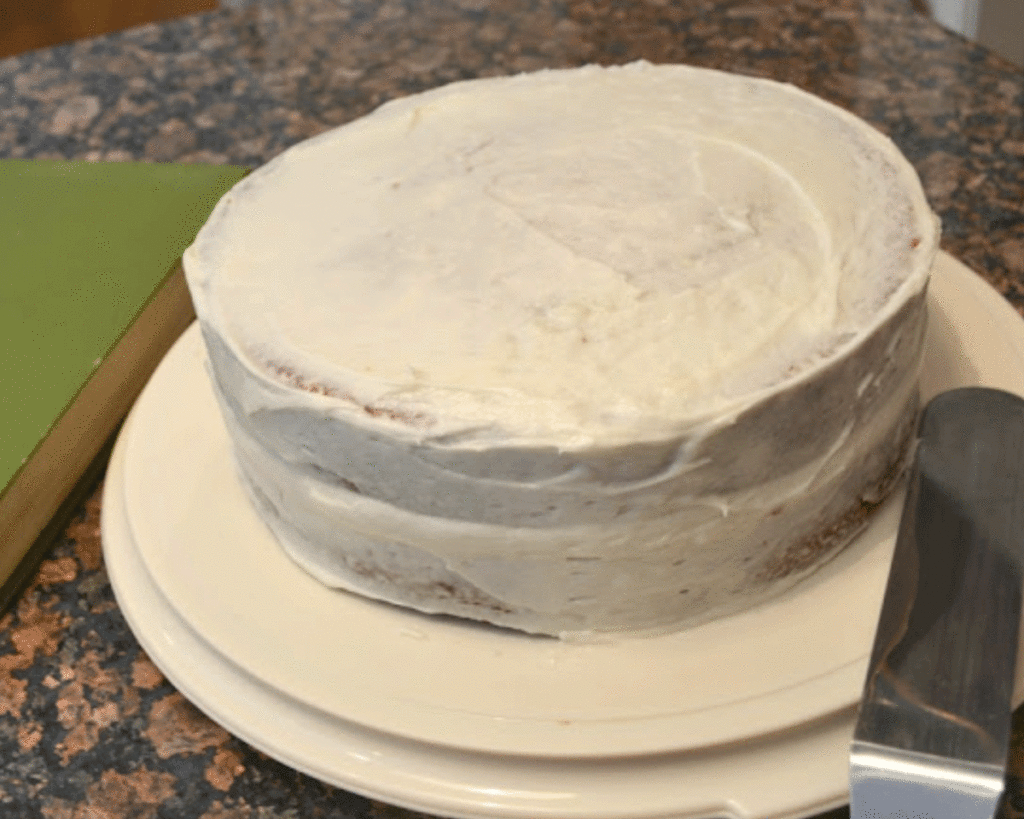 A cake frosted with a crumb coat to seal in the crumbs and yield a smooth final cake